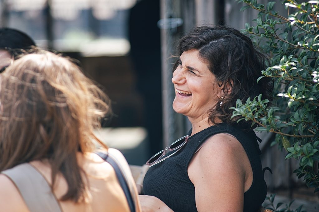 Multi coloured Summer wedding with a bride wearing green at The Barns at Lodge Farm. Essex documentary wedding photographer