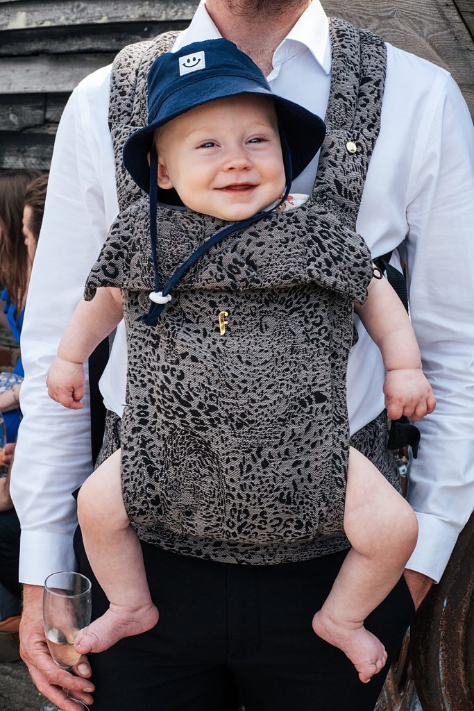 Multi coloured Summer wedding with a bride wearing green at The Barns at Lodge Farm. Essex documentary wedding photographer