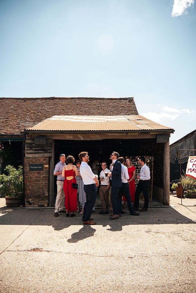 Multi coloured Summer wedding with a bride wearing green at The Barns at Lodge Farm. Essex documentary wedding photographer