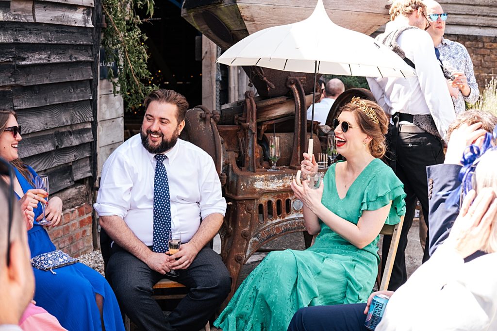 Multi coloured Summer wedding with a bride wearing green at The Barns at Lodge Farm. Essex documentary wedding photographer
