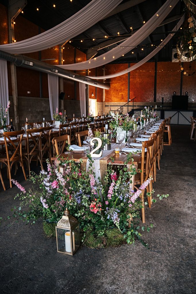 Multi coloured Summer wedding with a bride wearing green at The Barns at Lodge Farm. Essex documentary wedding photographer