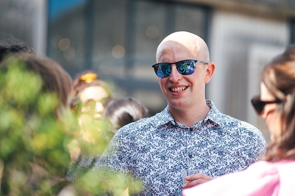 Multi coloured Summer wedding with a bride wearing green at The Barns at Lodge Farm. Essex documentary wedding photographer
