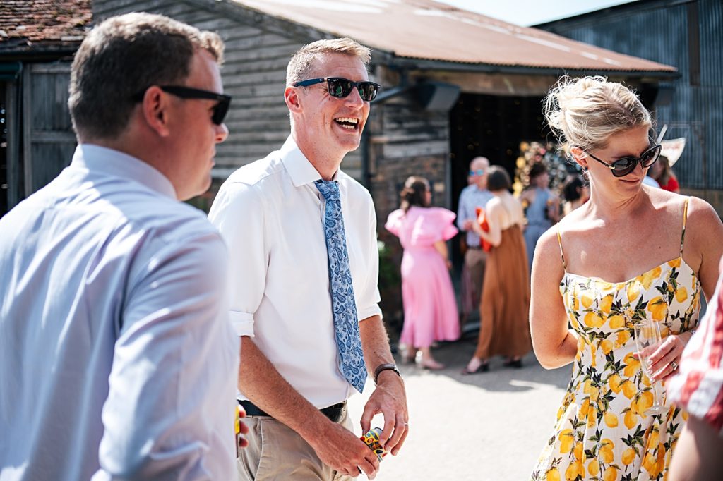 Multi coloured Summer wedding with a bride wearing green at The Barns at Lodge Farm. Essex documentary wedding photographer