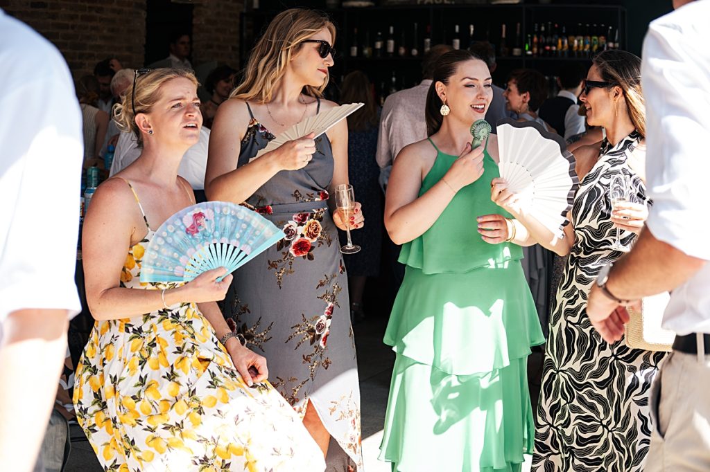 Multi coloured Summer wedding with a bride wearing green at The Barns at Lodge Farm. Essex documentary wedding photographer