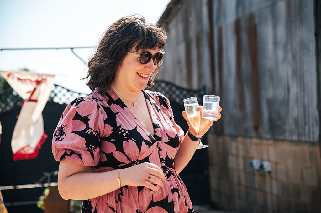 Multi coloured Summer wedding with a bride wearing green at The Barns at Lodge Farm. Essex documentary wedding photographer