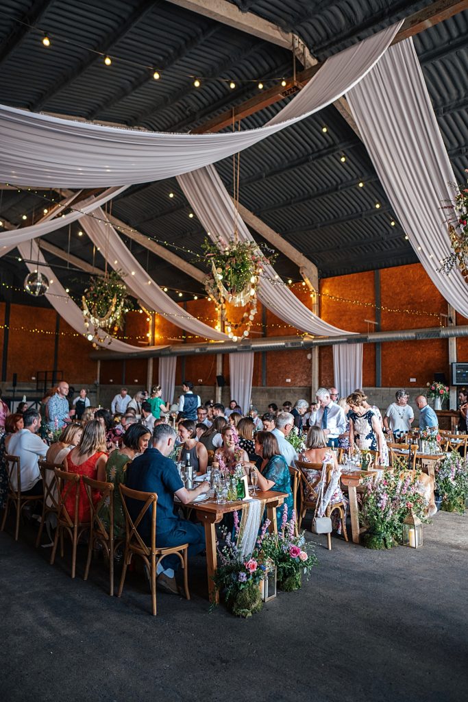 Multi coloured Summer wedding with a bride wearing green at The Barns at Lodge Farm. Essex documentary wedding photographer