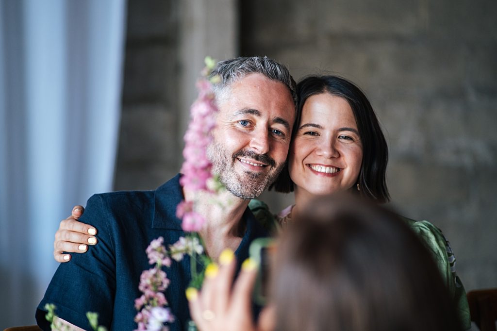 Multi coloured Summer wedding with a bride wearing green at The Barns at Lodge Farm. Essex documentary wedding photographer
