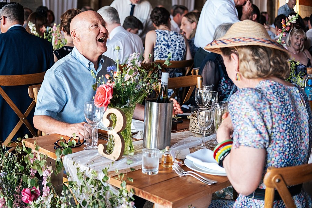 Multi coloured Summer wedding with a bride wearing green at The Barns at Lodge Farm. Essex documentary wedding photographer