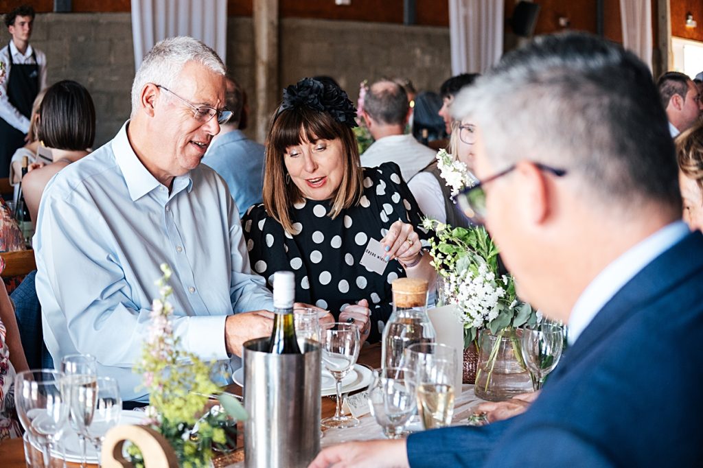 Multi coloured Summer wedding with a bride wearing green at The Barns at Lodge Farm. Essex documentary wedding photographer