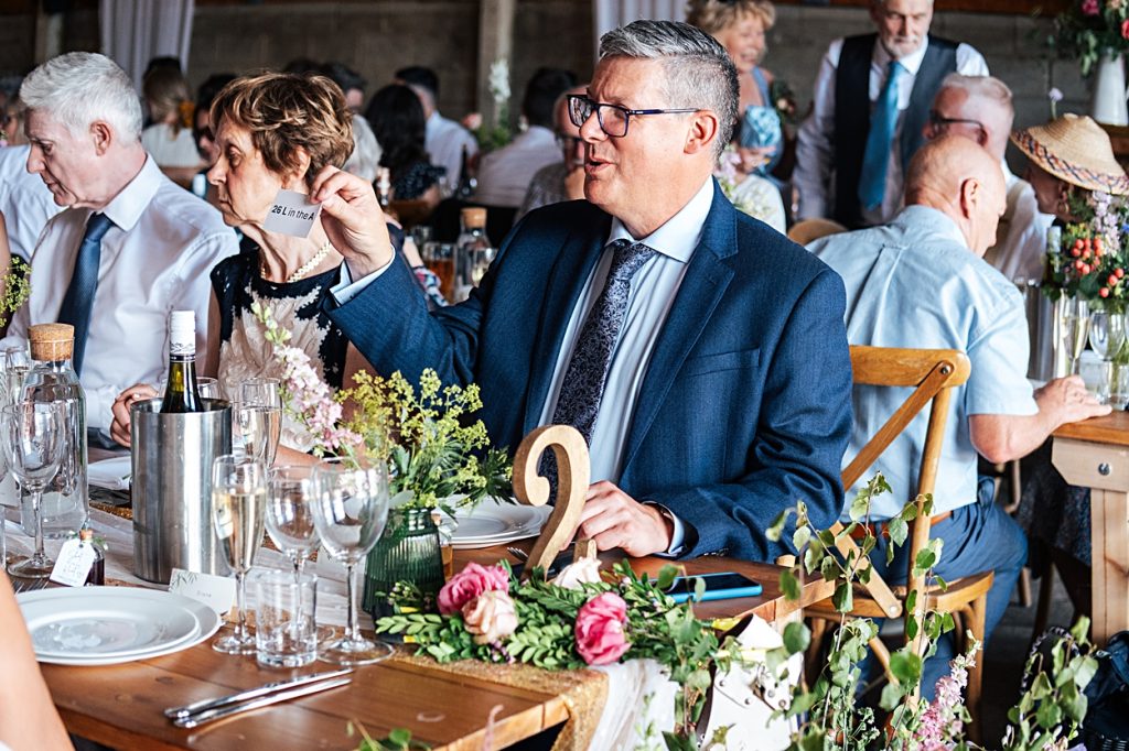 Multi coloured Summer wedding with a bride wearing green at The Barns at Lodge Farm. Essex documentary wedding photographer