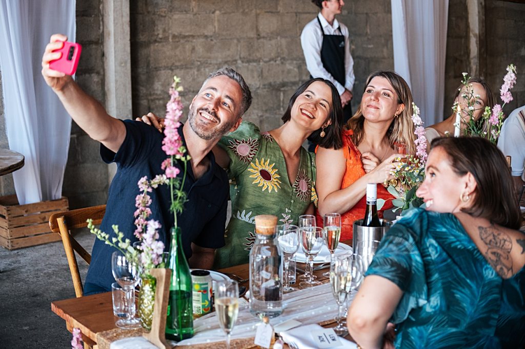 Multi coloured Summer wedding with a bride wearing green at The Barns at Lodge Farm. Essex documentary wedding photographer