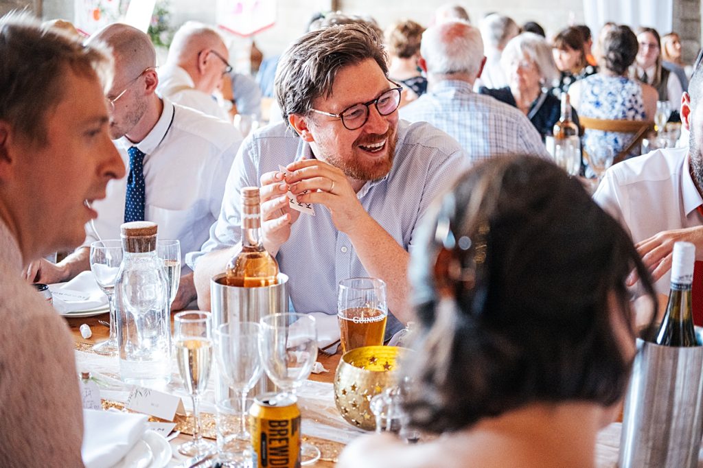 Multi coloured Summer wedding with a bride wearing green at The Barns at Lodge Farm. Essex documentary wedding photographer