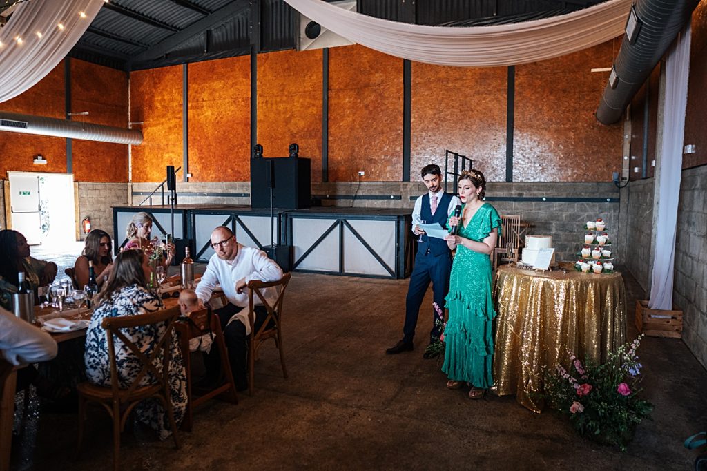Multi coloured Summer wedding with a bride wearing green at The Barns at Lodge Farm. Essex documentary wedding photographer