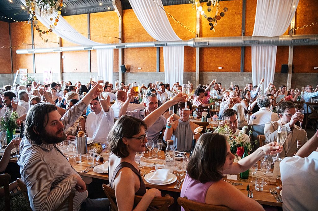 Multi coloured Summer wedding with a bride wearing green at The Barns at Lodge Farm. Essex documentary wedding photographer