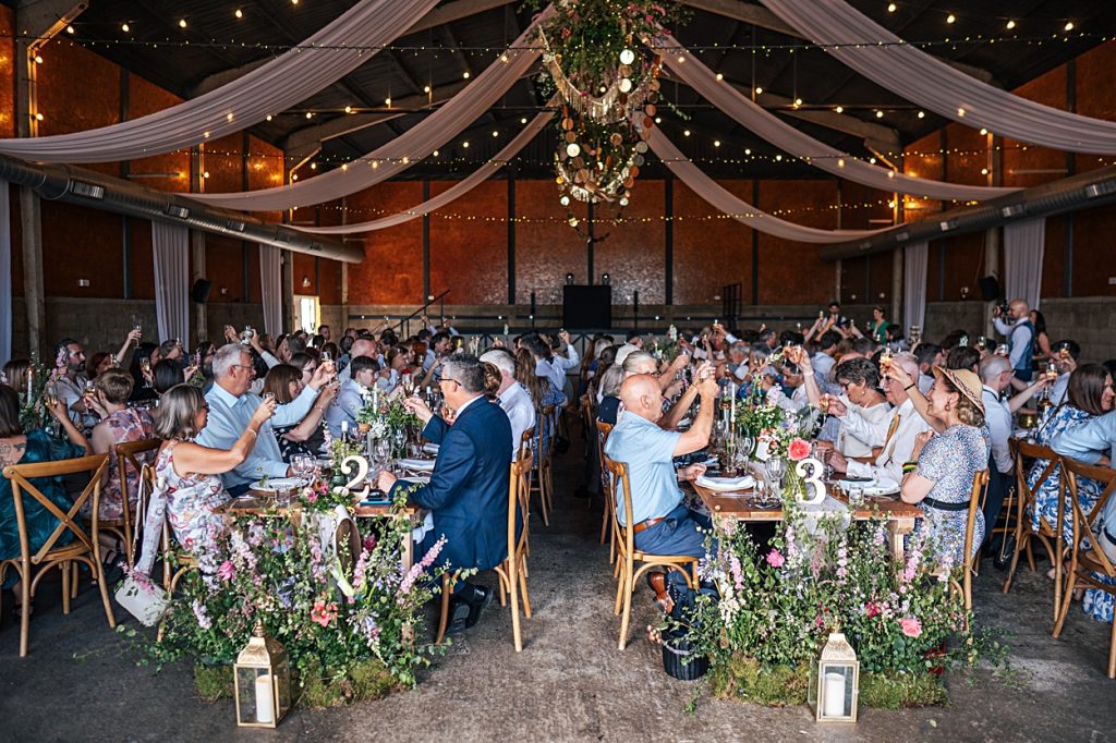 Multi coloured Summer wedding with a bride wearing green at The Barns at Lodge Farm. Essex documentary wedding photographer