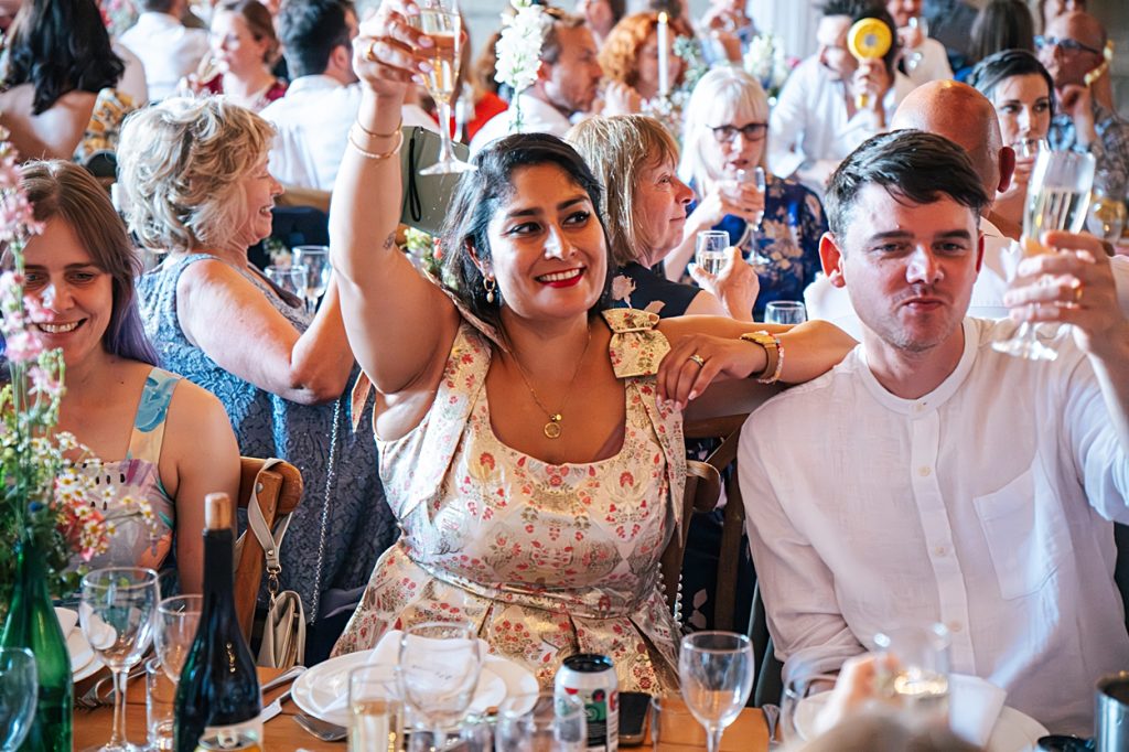 Multi coloured Summer wedding with a bride wearing green at The Barns at Lodge Farm. Essex documentary wedding photographer