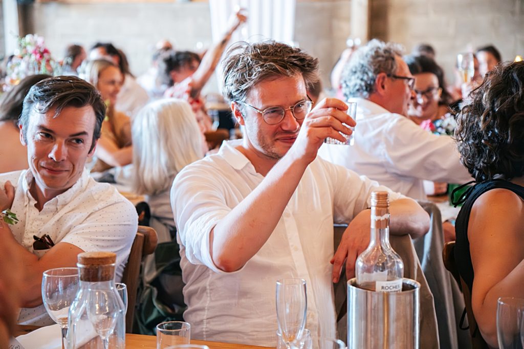 Multi coloured Summer wedding with a bride wearing green at The Barns at Lodge Farm. Essex documentary wedding photographer