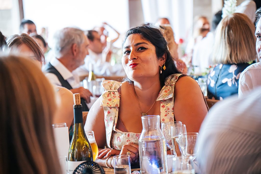 Multi coloured Summer wedding with a bride wearing green at The Barns at Lodge Farm. Essex documentary wedding photographer