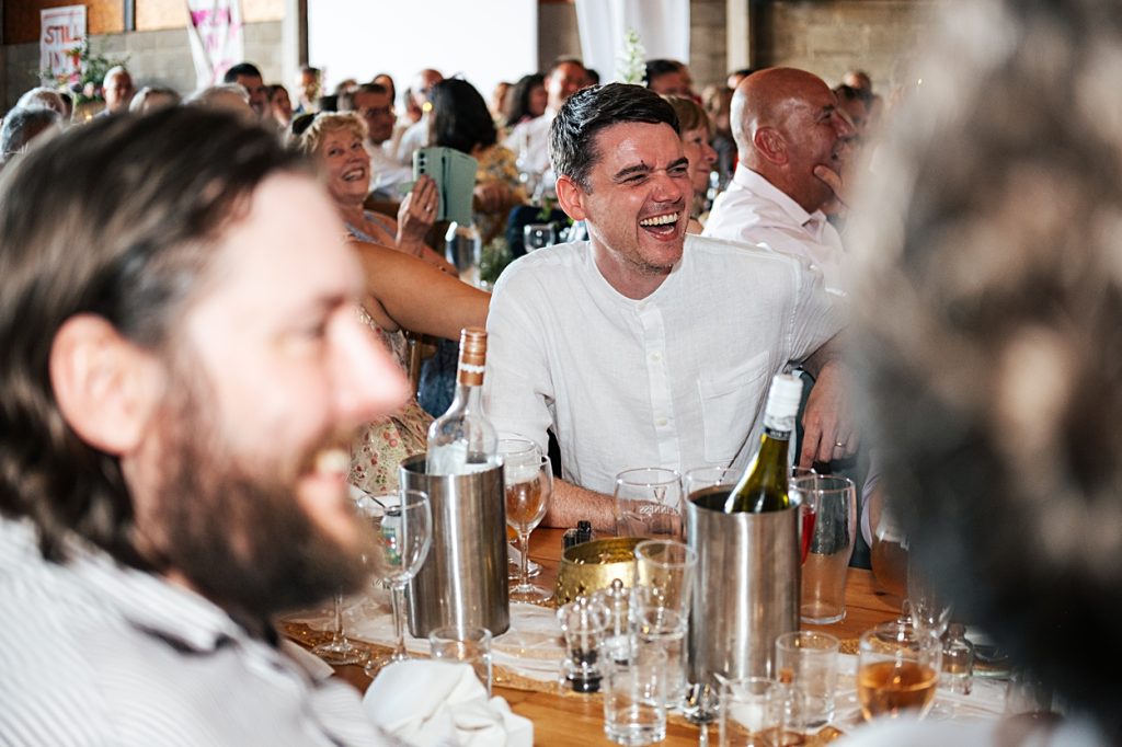 Multi coloured Summer wedding with a bride wearing green at The Barns at Lodge Farm. Essex documentary wedding photographer