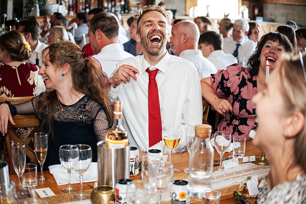 Multi coloured Summer wedding with a bride wearing green at The Barns at Lodge Farm. Essex documentary wedding photographer