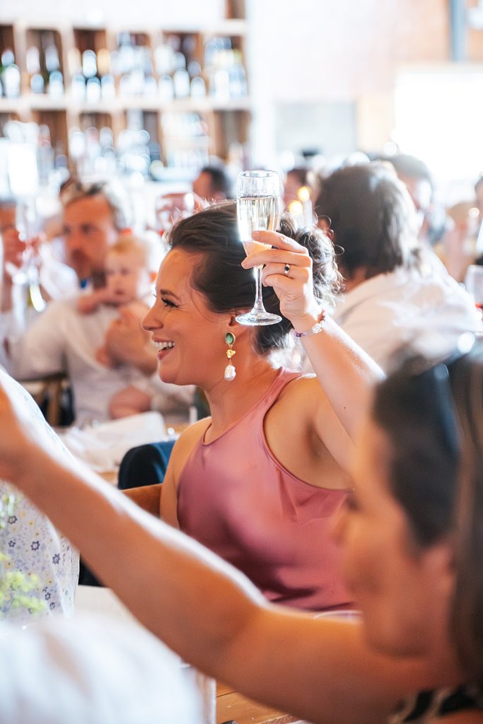 Multi coloured Summer wedding with a bride wearing green at The Barns at Lodge Farm. Essex documentary wedding photographer