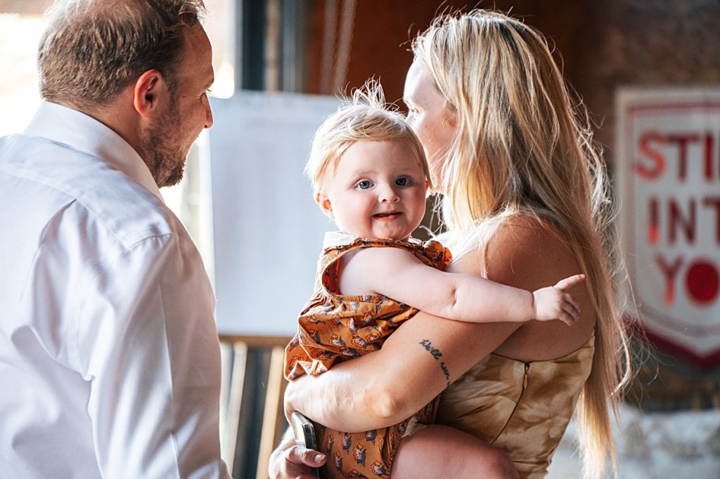 Multi coloured Summer wedding with a bride wearing green at The Barns at Lodge Farm. Essex documentary wedding photographer