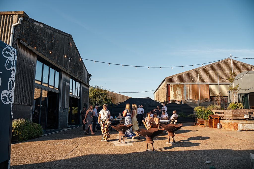 Multi coloured Summer wedding with a bride wearing green at The Barns at Lodge Farm. Essex documentary wedding photographer