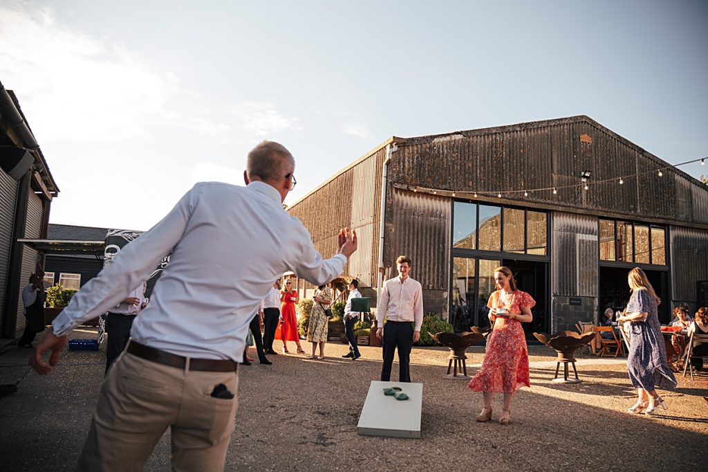 Multi coloured Summer wedding with a bride wearing green at The Barns at Lodge Farm. Essex documentary wedding photographer