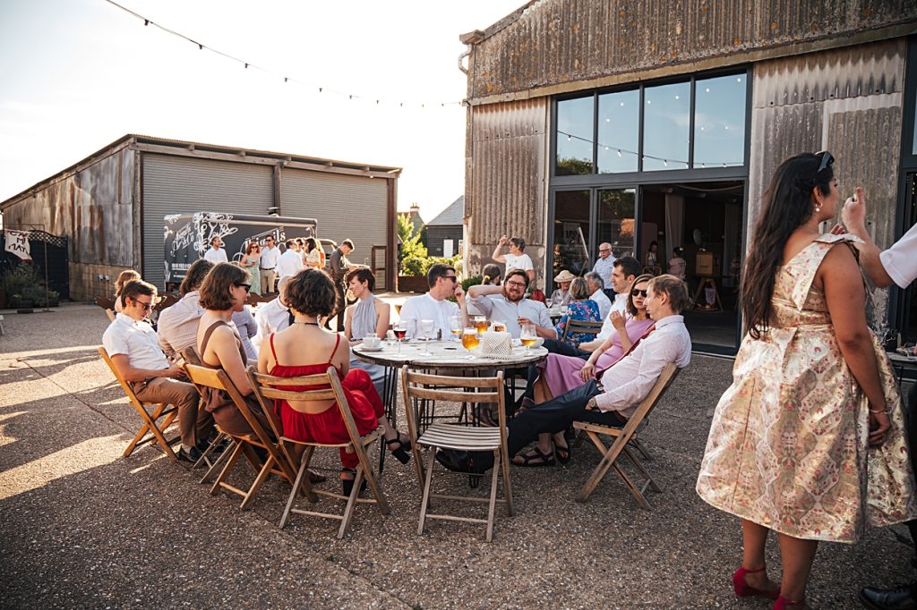 Multi coloured Summer wedding with a bride wearing green at The Barns at Lodge Farm. Essex documentary wedding photographer