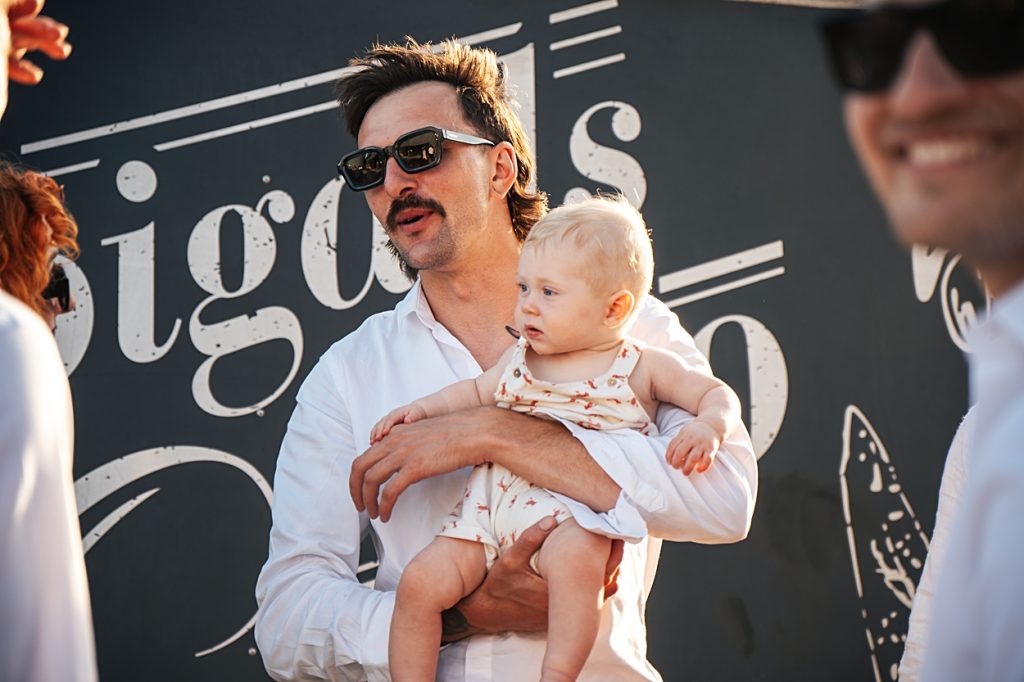 Multi coloured Summer wedding with a bride wearing green at The Barns at Lodge Farm. Essex documentary wedding photographer