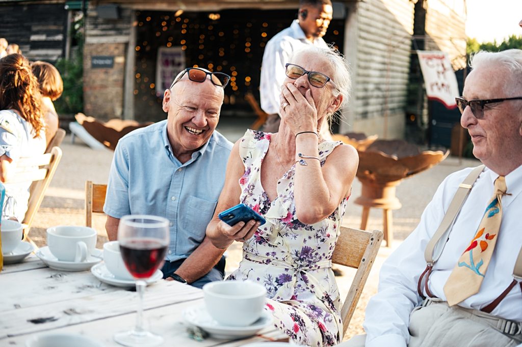 Multi coloured Summer wedding with a bride wearing green at The Barns at Lodge Farm. Essex documentary wedding photographer