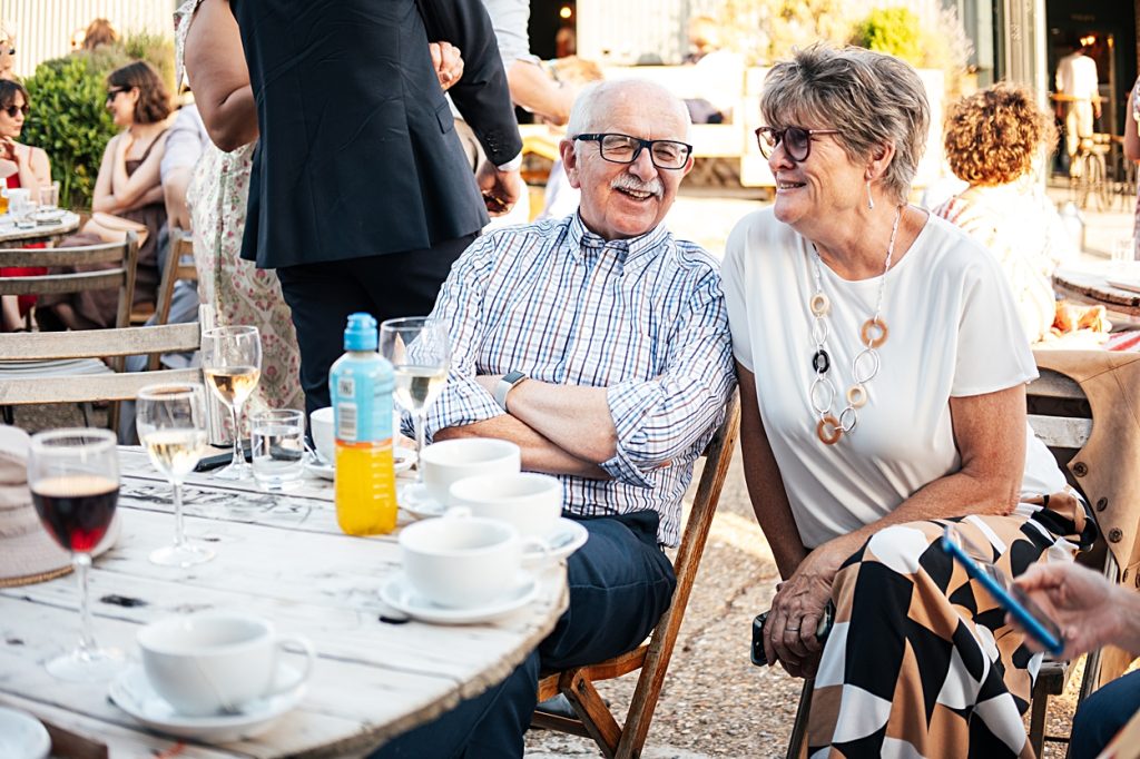 Multi coloured Summer wedding with a bride wearing green at The Barns at Lodge Farm. Essex documentary wedding photographer