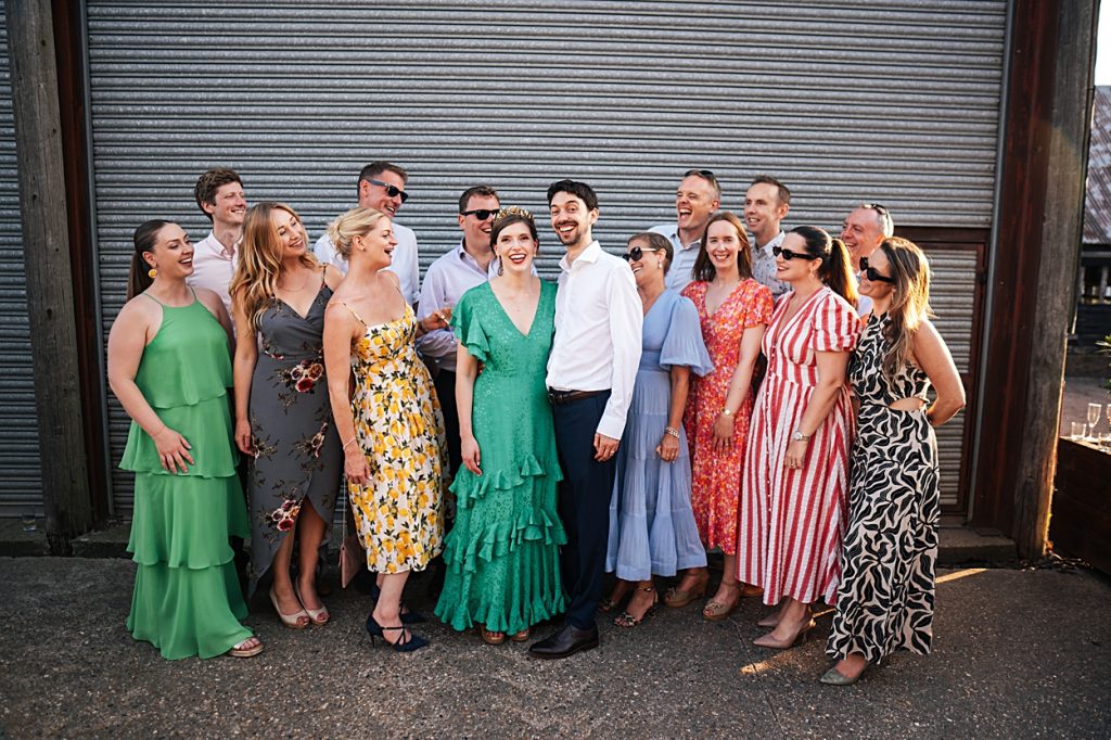 Multi coloured Summer wedding with a bride wearing green at The Barns at Lodge Farm. Essex documentary wedding photographer