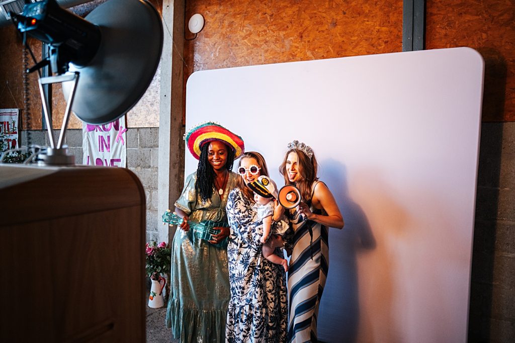 Multi coloured Summer wedding with a bride wearing green at The Barns at Lodge Farm. Essex documentary wedding photographer