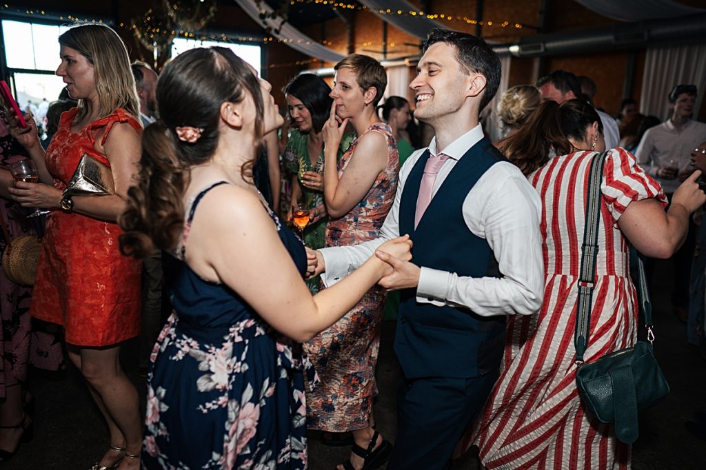 Multi coloured Summer wedding with a bride wearing green at The Barns at Lodge Farm. Essex documentary wedding photographer