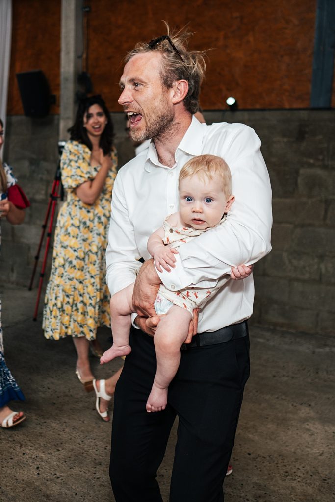 Multi coloured Summer wedding with a bride wearing green at The Barns at Lodge Farm. Essex documentary wedding photographer