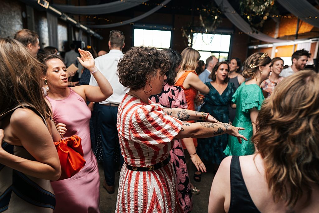 Multi coloured Summer wedding with a bride wearing green at The Barns at Lodge Farm. Essex documentary wedding photographer