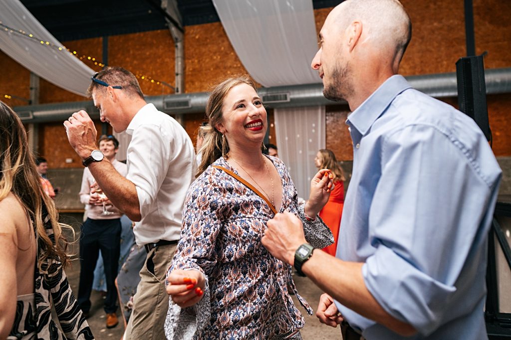 Multi coloured Summer wedding with a bride wearing green at The Barns at Lodge Farm. Essex documentary wedding photographer
