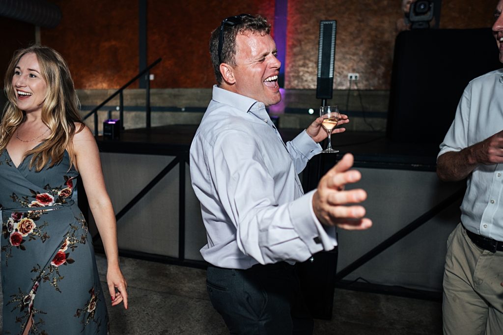 Multi coloured Summer wedding with a bride wearing green at The Barns at Lodge Farm. Essex documentary wedding photographer