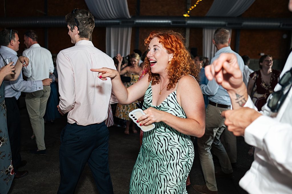 Multi coloured Summer wedding with a bride wearing green at The Barns at Lodge Farm. Essex documentary wedding photographer