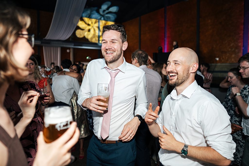 Multi coloured Summer wedding with a bride wearing green at The Barns at Lodge Farm. Essex documentary wedding photographer