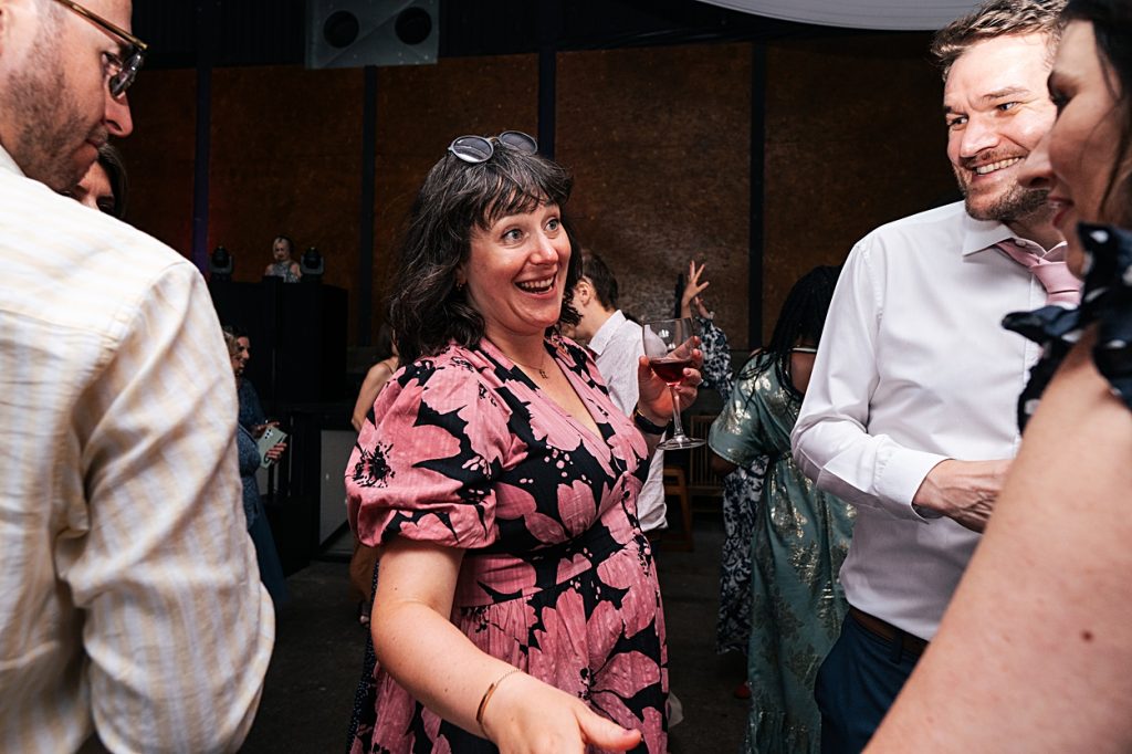 Multi coloured Summer wedding with a bride wearing green at The Barns at Lodge Farm. Essex documentary wedding photographer