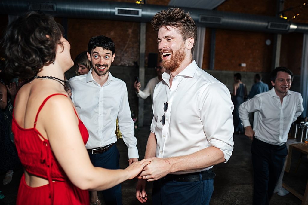 Multi coloured Summer wedding with a bride wearing green at The Barns at Lodge Farm. Essex documentary wedding photographer