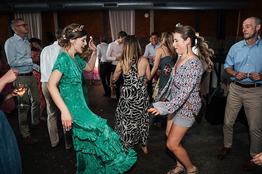 Multi coloured Summer wedding with a bride wearing green at The Barns at Lodge Farm. Essex documentary wedding photographer