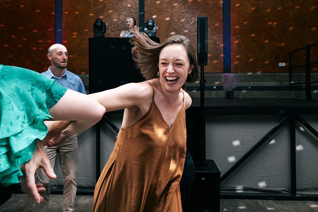 Multi coloured Summer wedding with a bride wearing green at The Barns at Lodge Farm. Essex documentary wedding photographer
