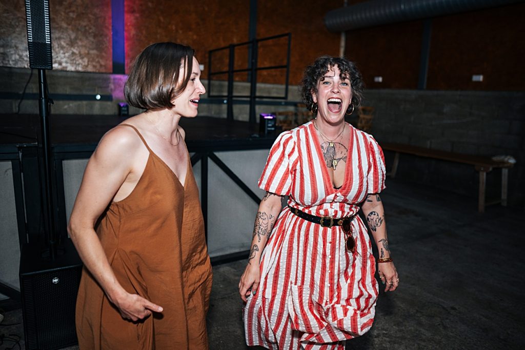 Multi coloured Summer wedding with a bride wearing green at The Barns at Lodge Farm. Essex documentary wedding photographer