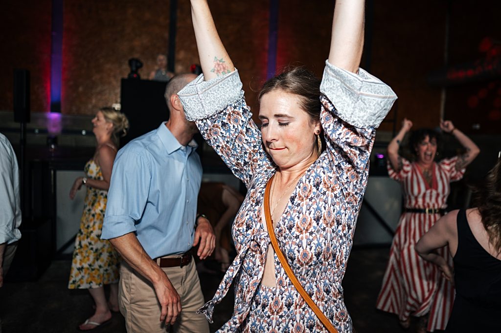 Multi coloured Summer wedding with a bride wearing green at The Barns at Lodge Farm. Essex documentary wedding photographer