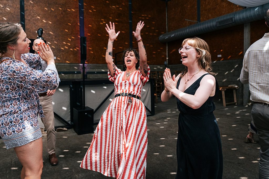 Multi coloured Summer wedding with a bride wearing green at The Barns at Lodge Farm. Essex documentary wedding photographer