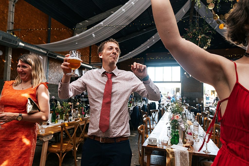 Multi coloured Summer wedding with a bride wearing green at The Barns at Lodge Farm. Essex documentary wedding photographer