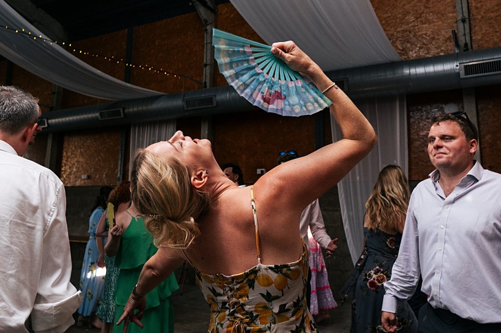 Multi coloured Summer wedding with a bride wearing green at The Barns at Lodge Farm. Essex documentary wedding photographer
